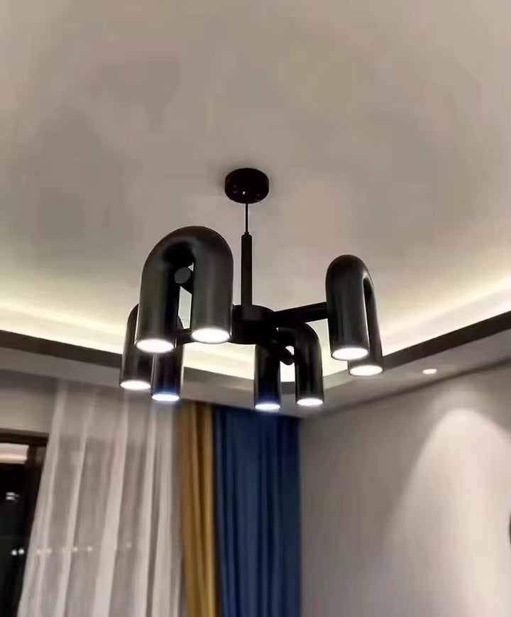 Suspension design tubulaire aux courbes en U en finition noir mat suspendue au plafond, mettant en valeur son design contemporain et son éclairage LED.