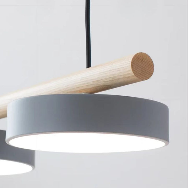 Gros plan sur un disque lumineux gris sous une barre en bois clair, au design scandinave épuré