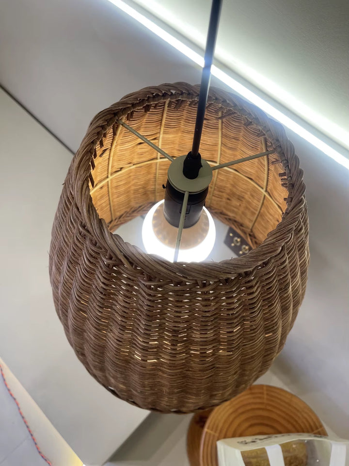 Vue intérieure d’une suspension en osier tressé avec ampoule apparente et finition artisanale chaleureuse