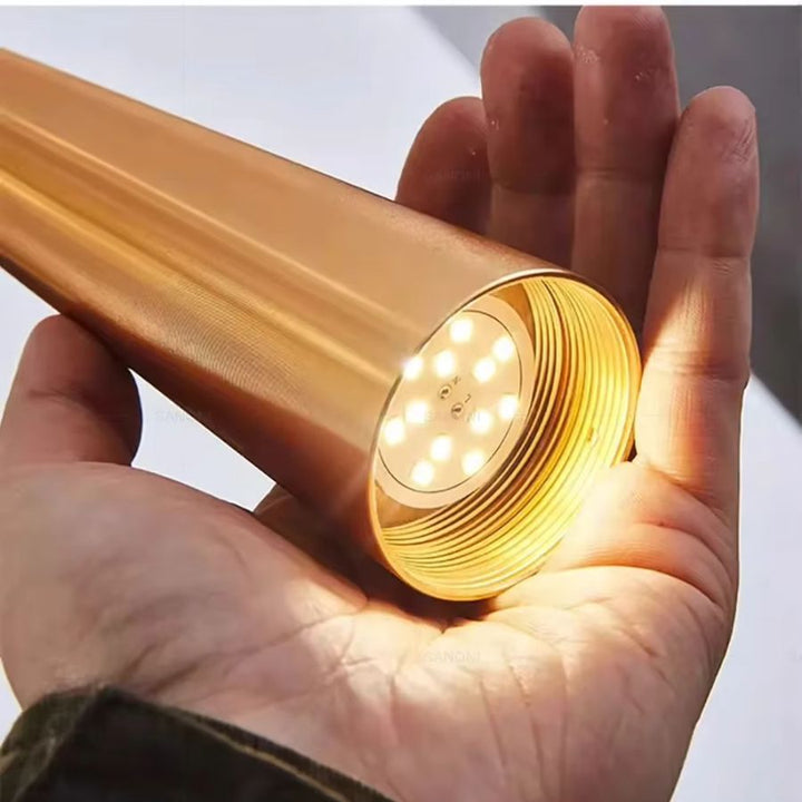 Gros plan sur l’éclairage LED inférieur d’une suspension aiguille dorée aux finitions métalliques raffinées