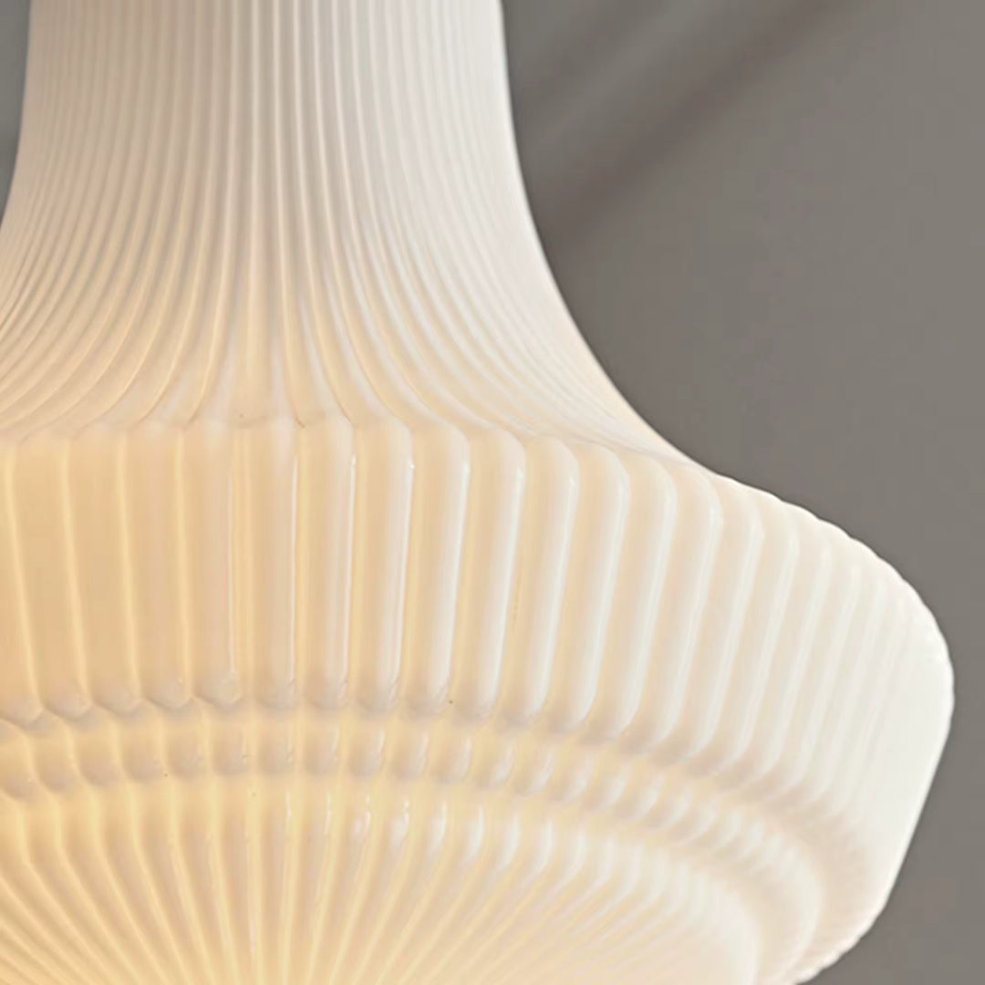 Gros plan sur le verre opalin nervuré, mettant en valeur ses reliefs sculptés et sa diffusion lumineuse chaleureuse