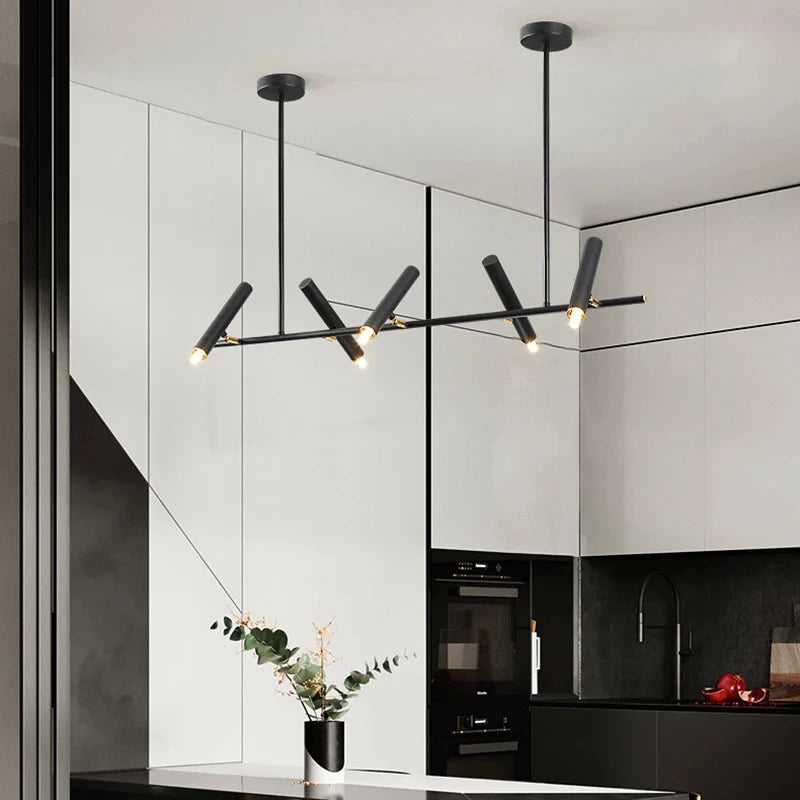 Éclairage suspendu minimaliste à cylindres LED orientés dans un intérieur moderne.