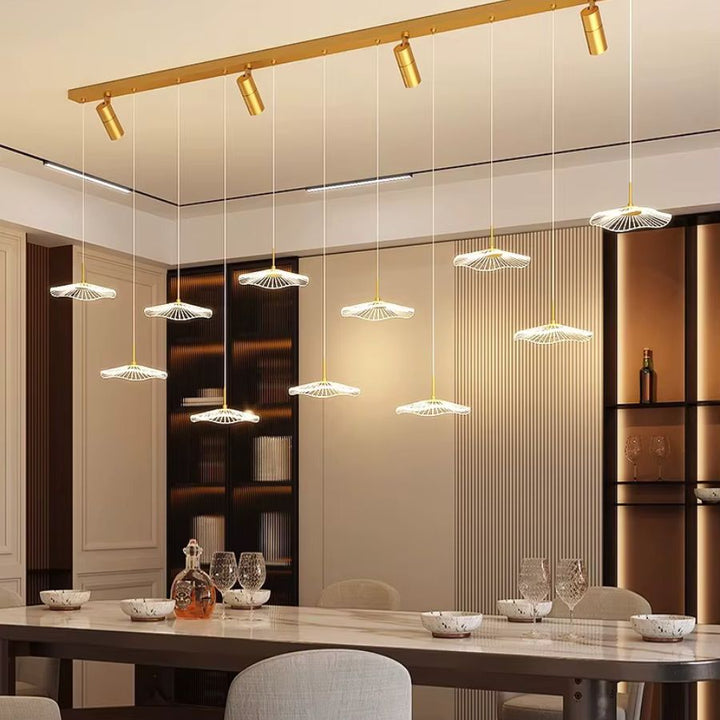 Onze ombrelles LED suspendues à une rampe dorée avec quatre spots orientables illuminent une salle à manger chic et moderne.