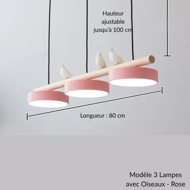 Avec ses disques rose poudré et ses oiseaux blancs, ce luminaire suspendu en bois mêle douceur et design nordique