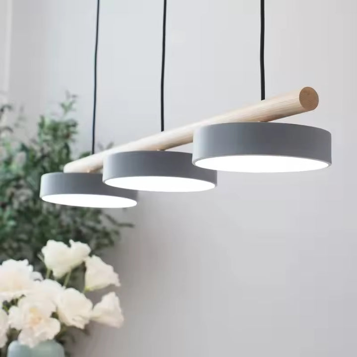 Vue en perspective de trois disques LED gris sous une barre en bois clair, dans un style scandinave épuré