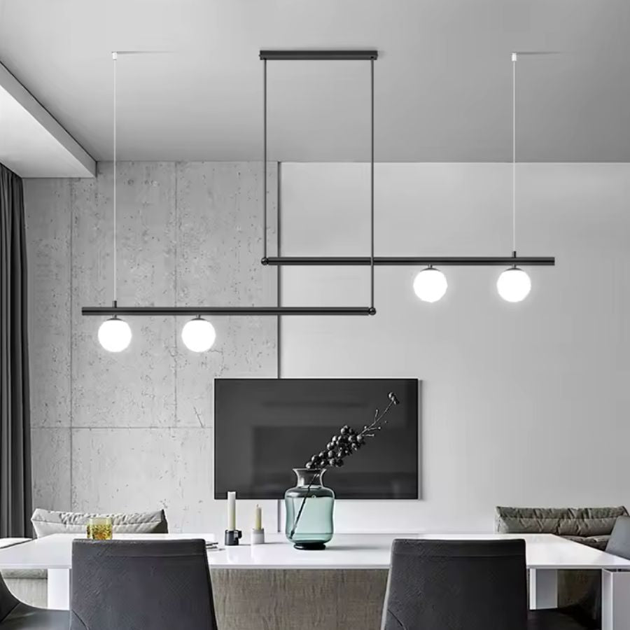 Luminaire noir à lignes décalées et quatre globes opalins, intégré dans un salon contemporain au style minimaliste