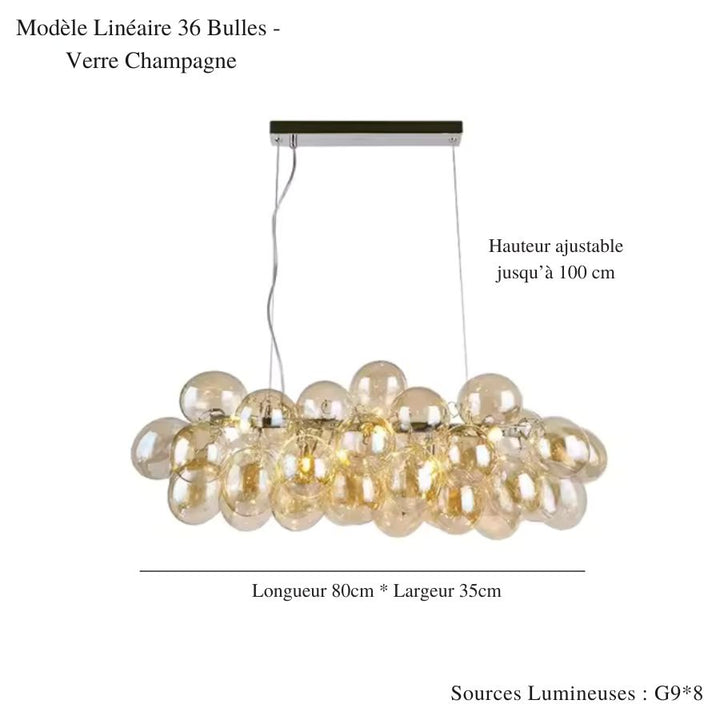 Déployé sur 80 cm, ce lustre grappe linéaire en verre champagne offre un design aérien et contemporain