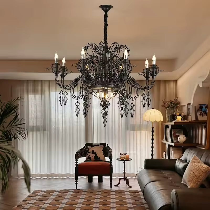 Dans un salon au décor vintage, lustre noir baroque à bras en volutes, pampilles géométriques et bougies lumineuses.