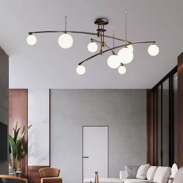 Dans un salon moderne aux lignes épurées, lustre noir aérien à branches entrecroisées et globes blancs au design sculptural.