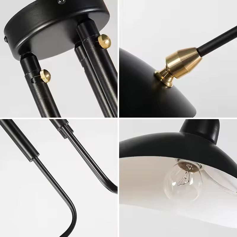 Détails d'un lustre noir industriel : fixations dorées, bras métalliques courbés et coupole avec ampoule apparente.
