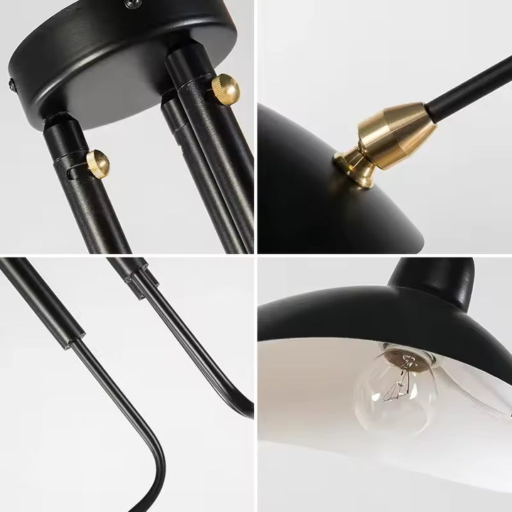 Détails d'un lustre noir industriel : fixations dorées, bras métalliques courbés et coupole avec ampoule apparente.