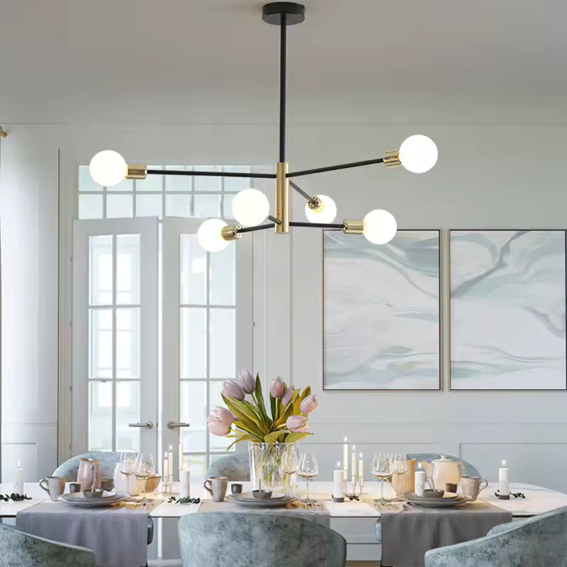 Lustre noir et doré à bras rayonnants et 6 ampoules apparentes, mis en scène dans une salle à manger lumineuse