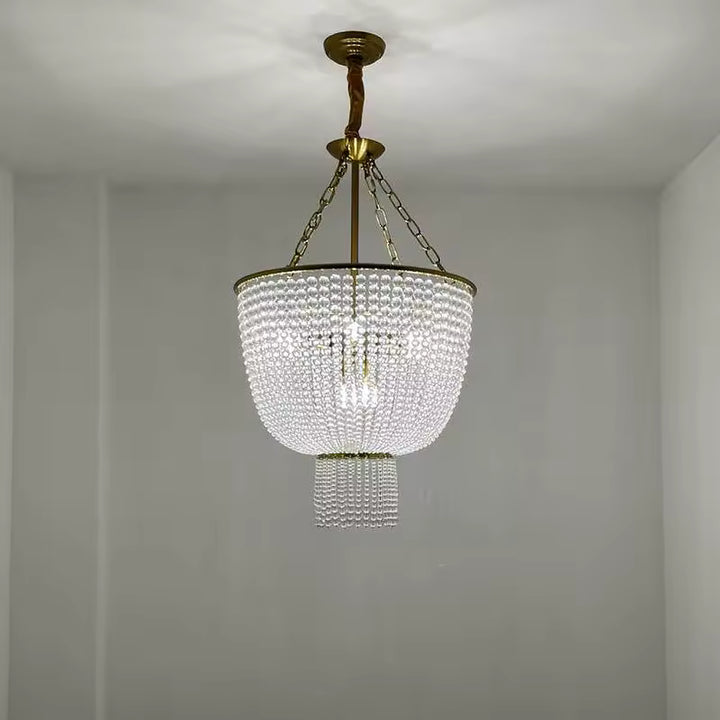 Lustre à perles de cristal transparentes au style classique chic, avec structure dorée et cascade lumineuse en forme de coupe.