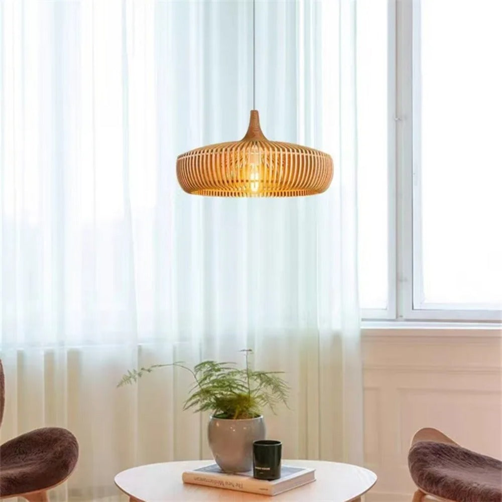 Suspension en bois ajouré placée près d'une grande fenêtre dans un décor épuré.