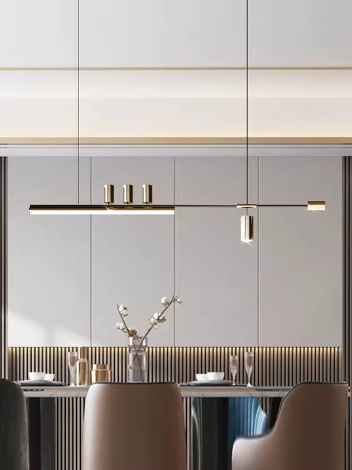 Éclairage suspendu noir et doré au style design italien, avec structure asymétrique et lignes fines au-dessus du repas