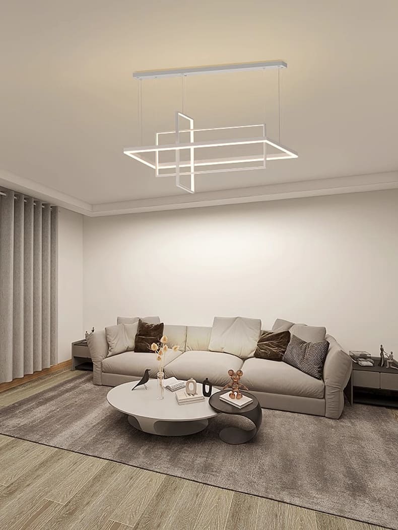 Grand luminaire suspendu design dans un salon lumineux au style scandinave et épuré.