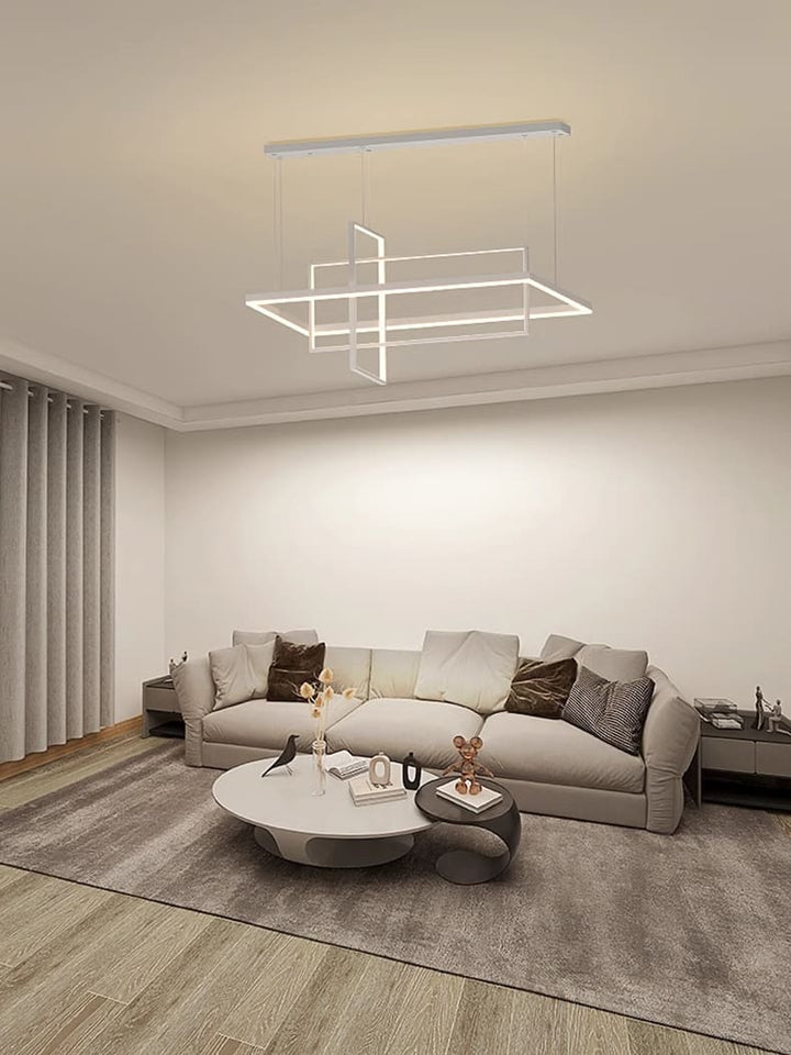 Grand luminaire suspendu design dans un salon lumineux au style scandinave et épuré.