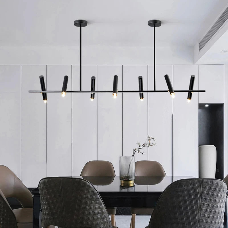 Suspension barre LED noire au design moderne installée au-dessus d'une table à manger chic.