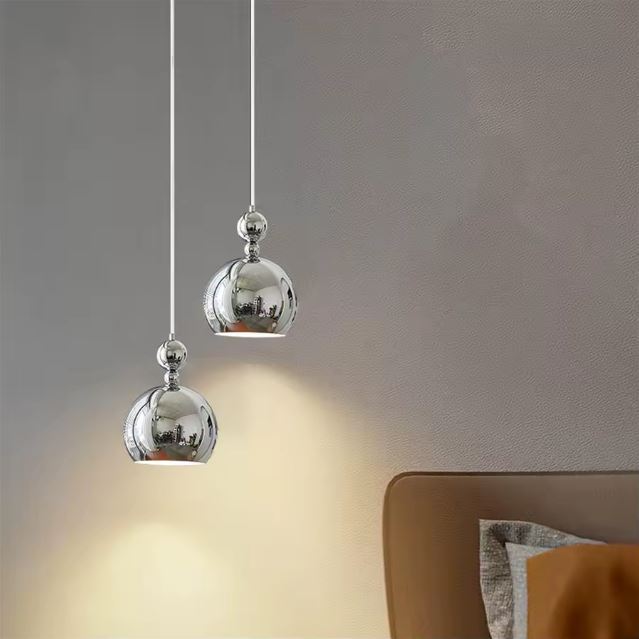 Suspension boule argentée moderne avec un design épuré pour éclairage intérieur élégant et raffiné.