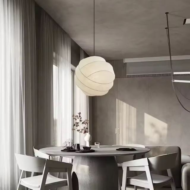 Suspension boule en tissu pour une décoration intérieure moderne, apportant une lumière chaleureuse et élégante à votre salle à manger.