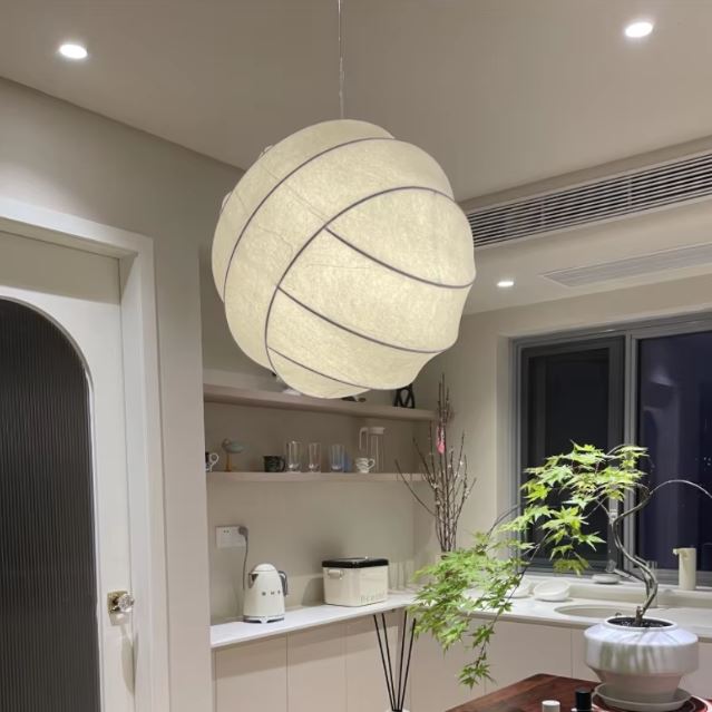 Suspension boule en tissu suspendue, idéale pour un intérieur moderne avec un éclairage doux et chaleureux.