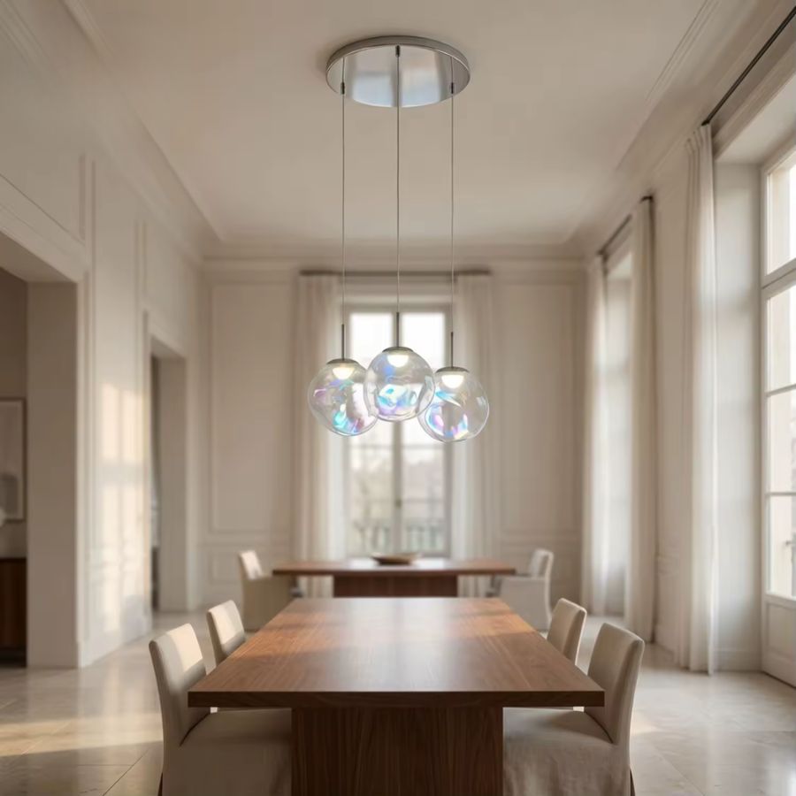 Suspension à trois sphères en verre irisé dans une salle à manger lumineuse au style élégant et contemporain