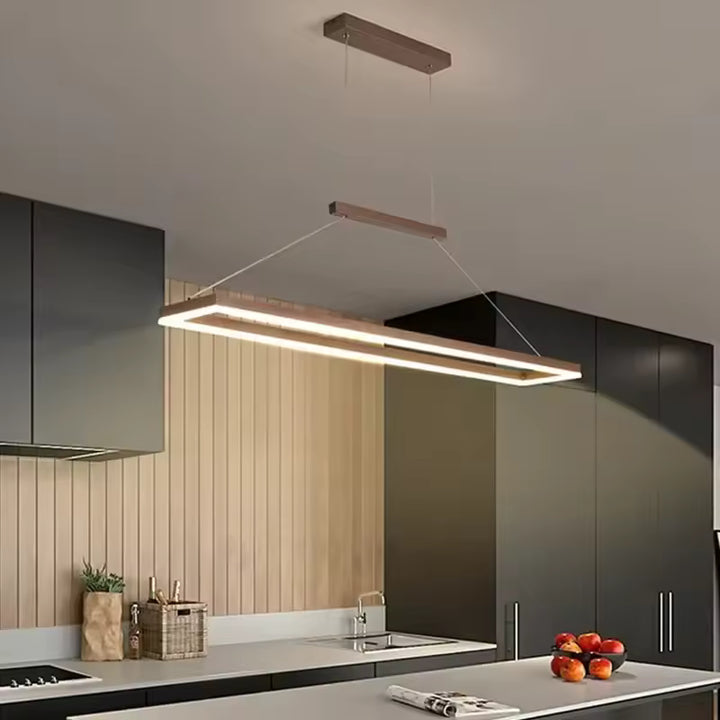 Suspension cadre rectangulaire flottant LED au style minimaliste et contemporain au-dessus d’un îlot de cuisine