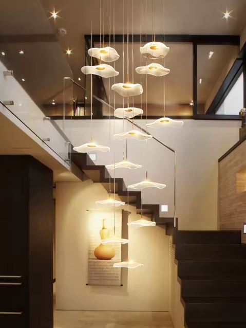 Suspension cascade moderne en dégradé, parfaite pour éclairer avec style un espace à double hauteur sous plafond.