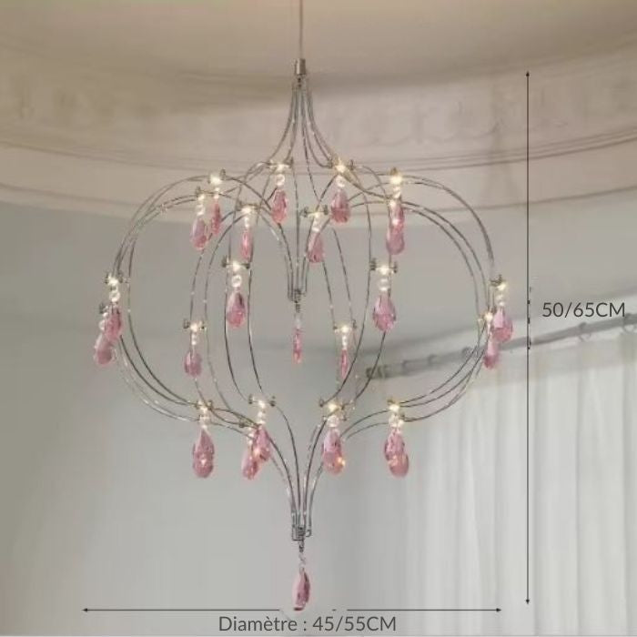 Suspension cœur en acier inoxydable avec pampilles en cristal rose et câble réglable au style délicat.