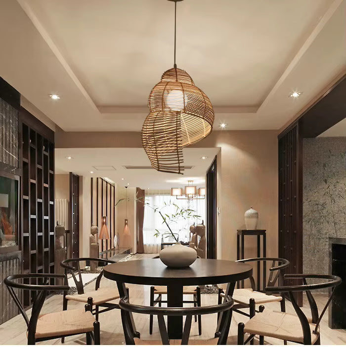 Dans une salle à manger chaleureuse, cette suspension en rotin tressé dévoile un style naturel, bohème et sculptural
