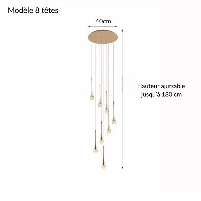 Suspension cristal doré à 8 têtes, réglable jusqu’à 180 cm, parfaite pour un coin repas, une cage d’escalier ou un hall contemporain.
