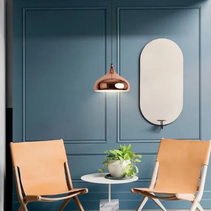 Suspension cuivre rose brillante dans un salon, luminaire vintage moderne aux lignes douces et au design raffiné.