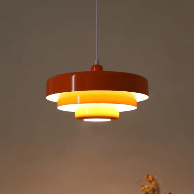 Suspension danoise orange au style vintage scandinave, parfaite pour une ambiance chaleureuse dans un salon ou une cuisine.