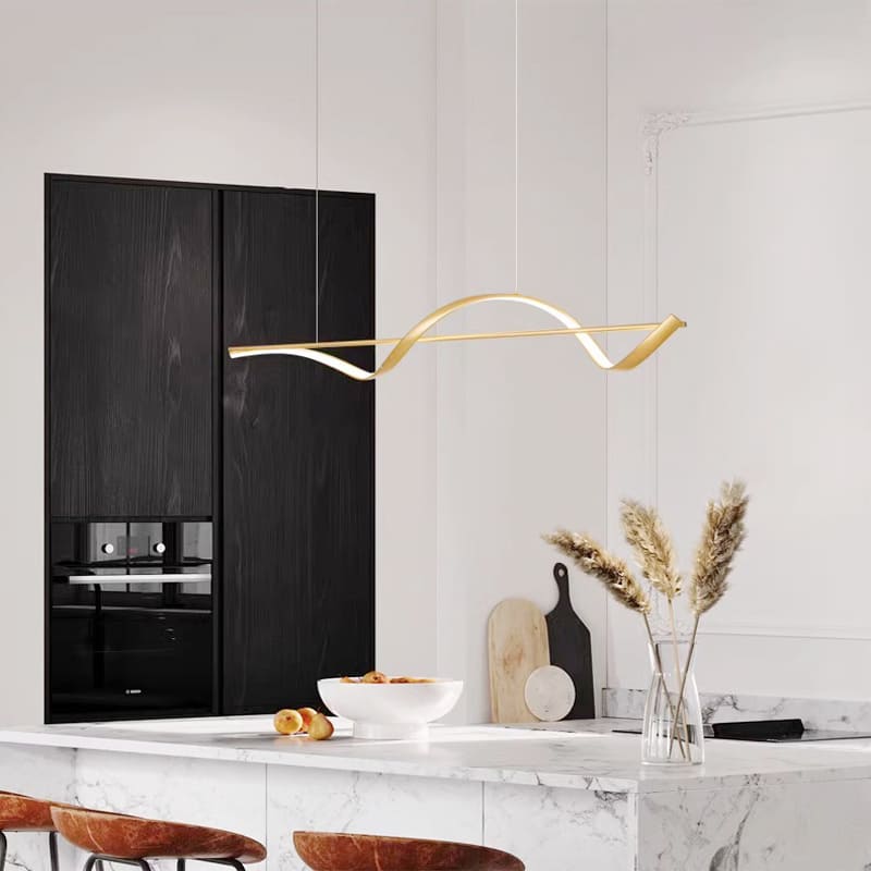 Suspension dorée luxueuse apportant une touche chaleureuse et design dans une cuisine ouverte.