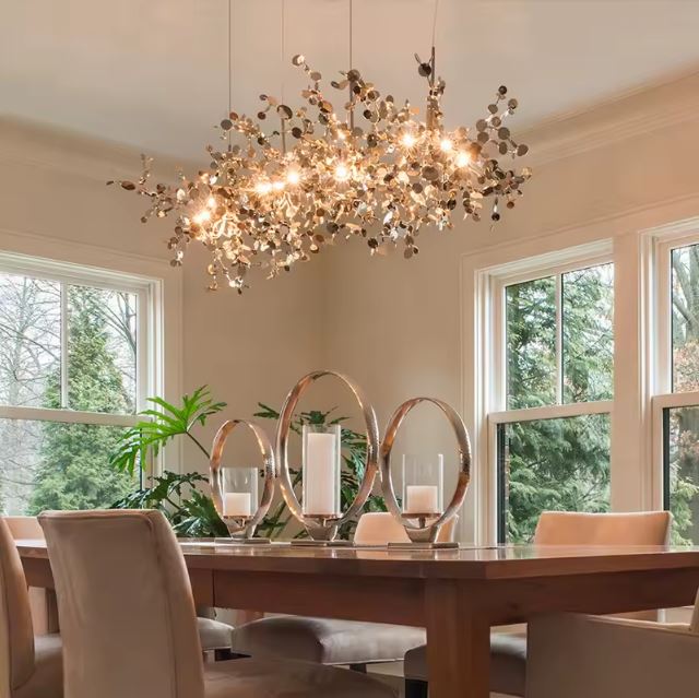 Suspension fleur doré illuminant une table à dîner avec style.