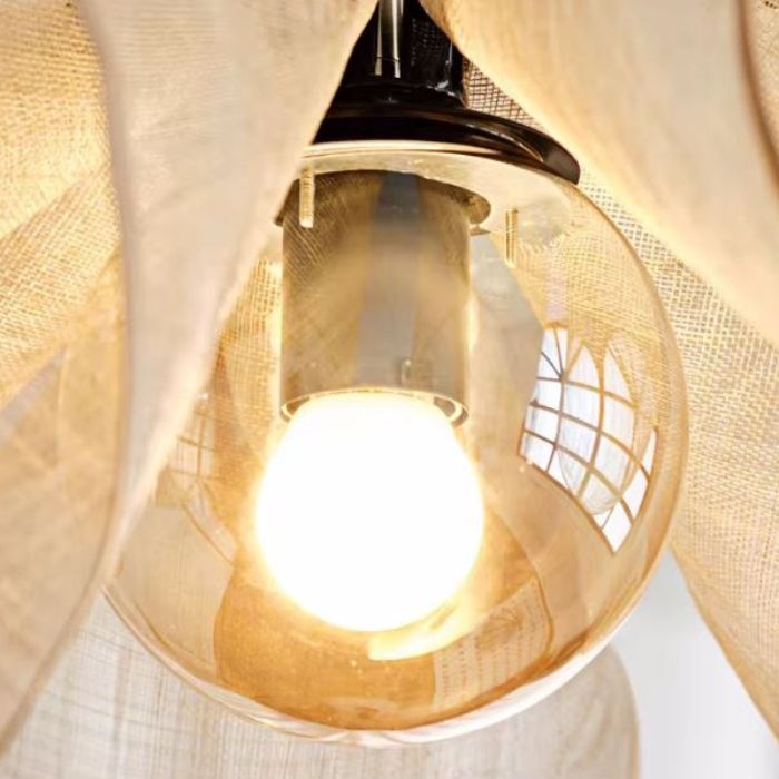 Gros plan sur une suspension fleur en tissu diffusant une lumière éclatante, idéale pour une ambiance chaleureuse et naturelle.