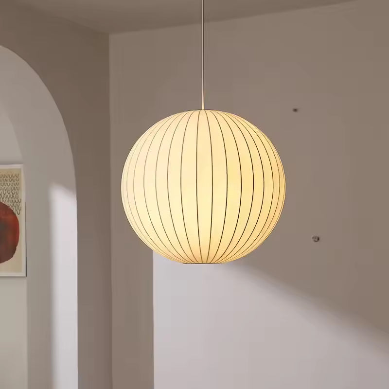 Suspension globe plissé en soie blanche au style japandi et japonais, diffusant une lumière douce et chaleureuse