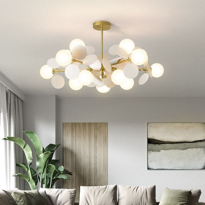 Suspension à globes et pétales blanches créant une atmosphère cosy dans un grand salon moderne le soir