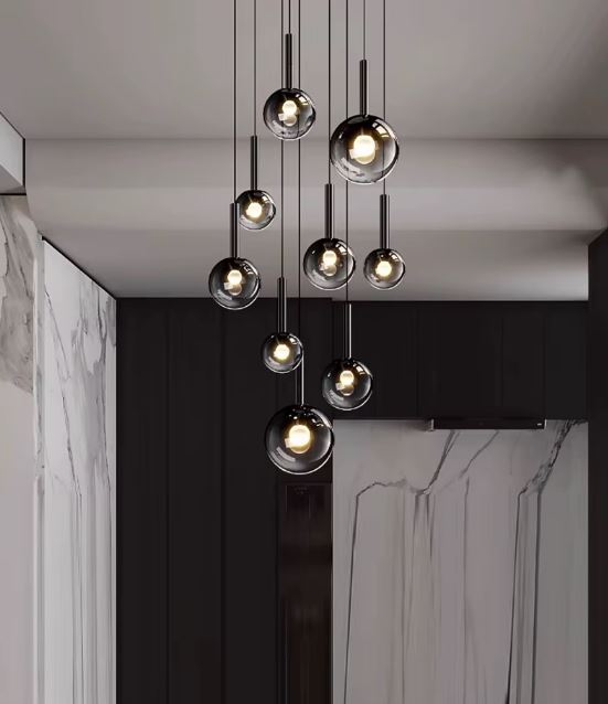 Suspension en cascade de globes en verre fumé noir, style contemporain élégant pour séjour moderne.