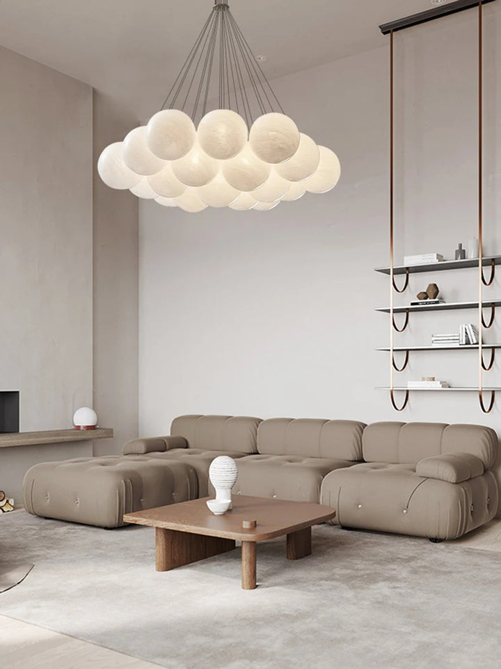 Suspension globes en verre opalin blanc suspendue au-dessus d'un salon moderne au mobilier minimaliste