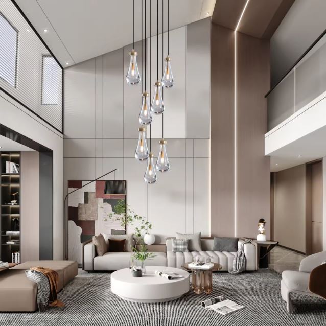 Suspension gouttes en verre transparent pour plafond haut au design aérien et contemporain avec détails laiton