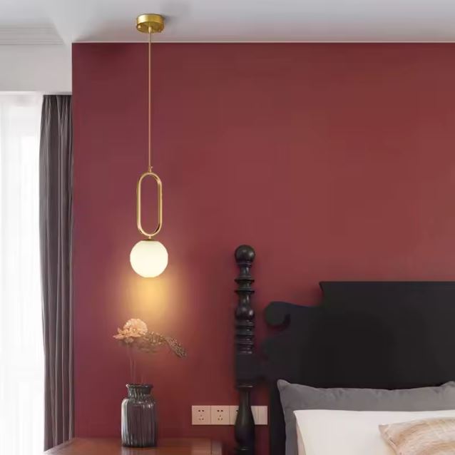 Suspension minimaliste en laiton avec globe en verre blanc, luminaire chic esprit contemporain idéal en lampe de chevet suspendue.