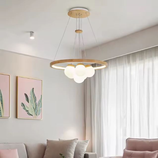 Suspension LED en bois avec globes blancs opalins, idéale pour un salon scandinave élégant à l’ambiance douce et lumineuse.