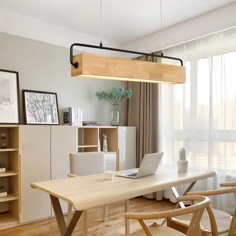 Dans un bureau lumineux au style scandinave, suspension linéaire en bois clair à armature noire, au-dessus d'une table en bois.