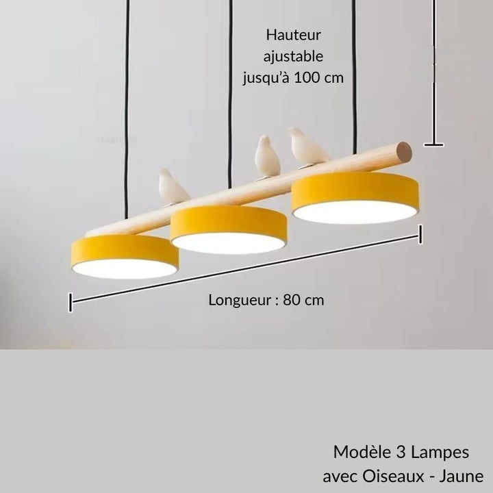 Réveillée par trois disques jaunes, cette suspension en bois avec oiseaux affiche un esprit ludique et contemporain