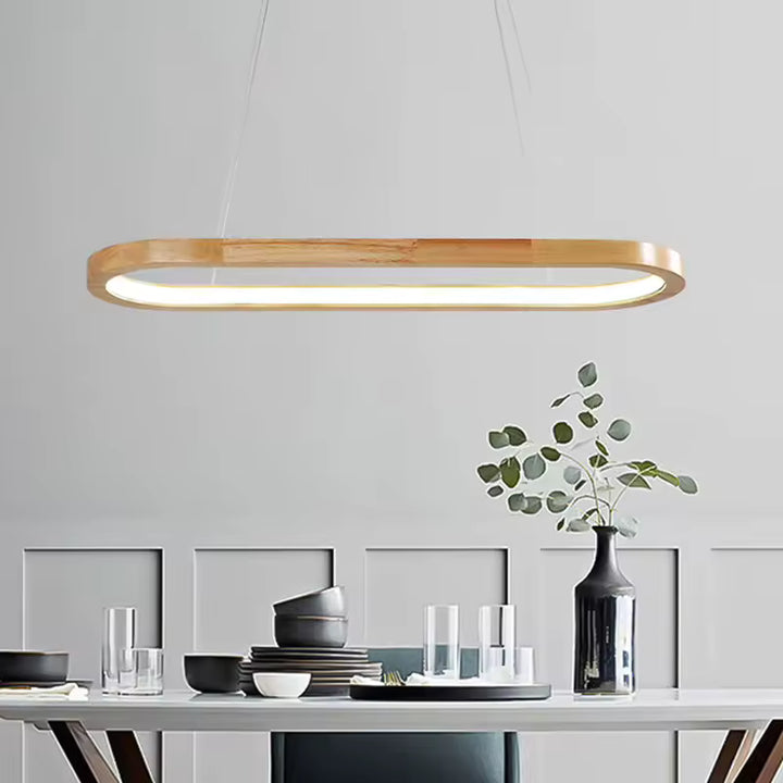 Au-dessus de la table, cette suspension ovale en bois à LED intégrée affirme un style scandinave, épuré et moderne