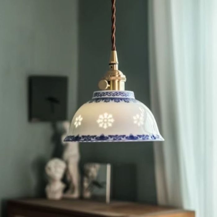 Suspension en porcelaine fine aux arabesques bleues ajourées, au charme vintage et artisanal rappelant les luminaires campagne chic.