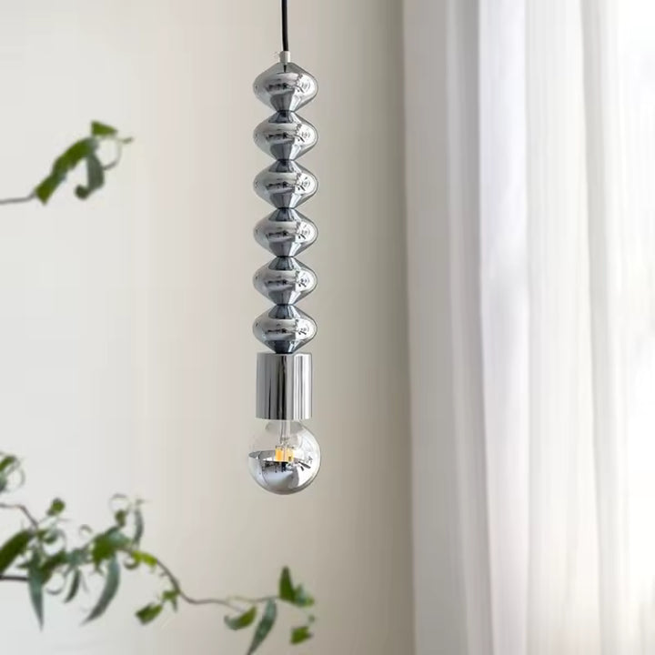 Allure sculpturale pour cette suspension totem chromée à ampoule transparente, au design moderne et épuré
