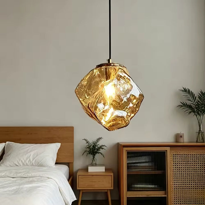 Éclairage suspendu en verre ambré façon roche, au design organique et chaleureux dans une chambre contemporaine