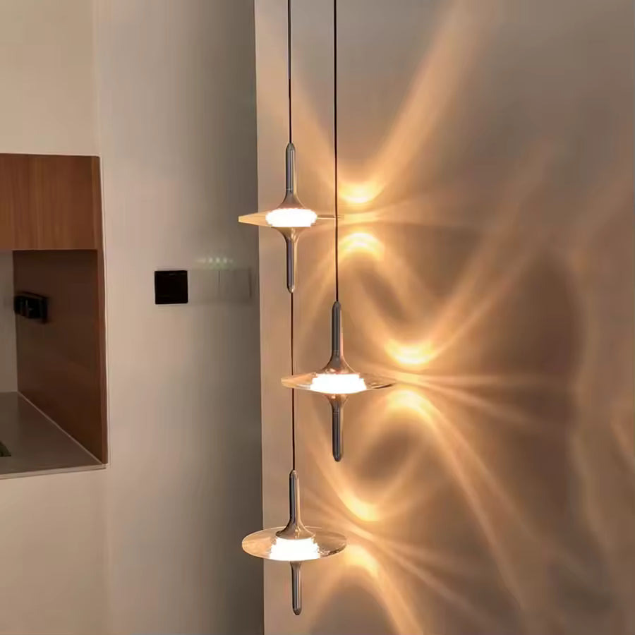 Cascade de suspensions étoile en cristal K9 et métal chromé, projetant des halos lumineux au style design et raffiné